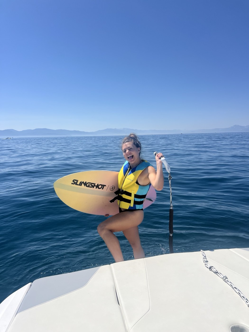 Wake surfer holding a board on Lake Tahoe
